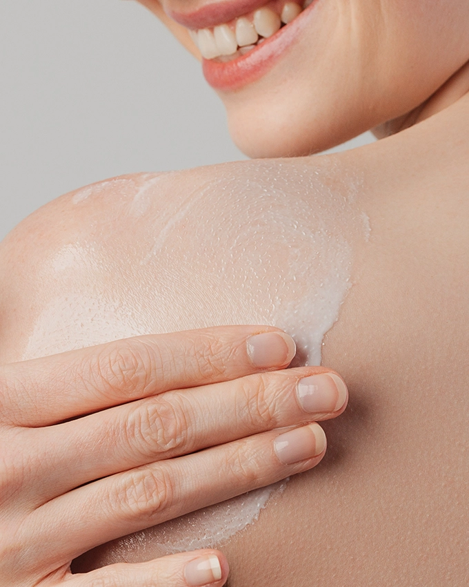 Sensicura body balm is applied to a woman's shoulder