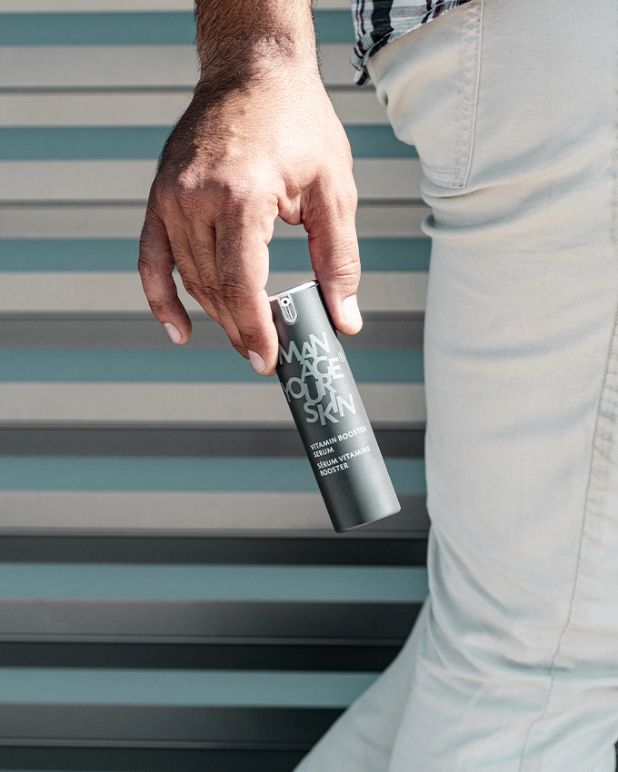 Man holding the Vitamin Booster Serum in his hand