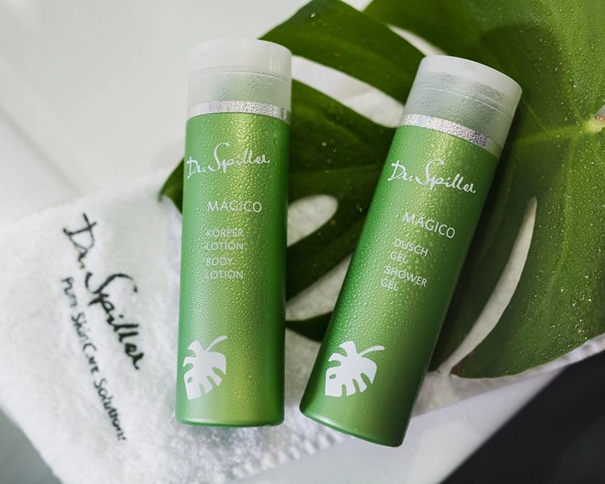 MAGICO body lotion and shower gel next to each other covered with water beads