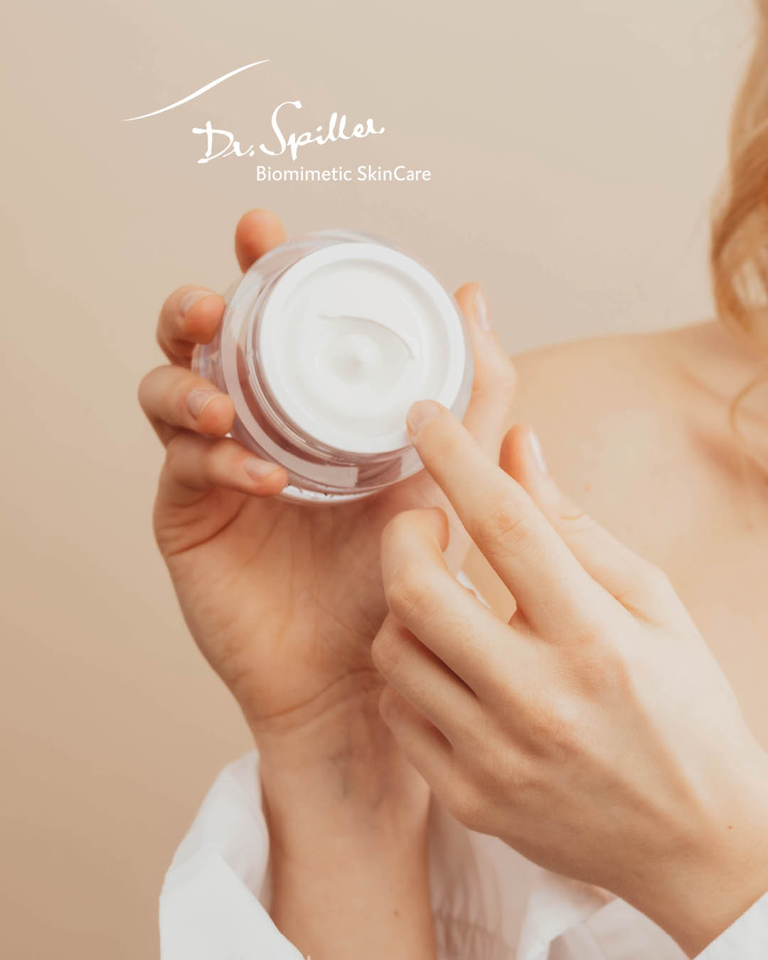 Woman holding open jar of facial care in her hands