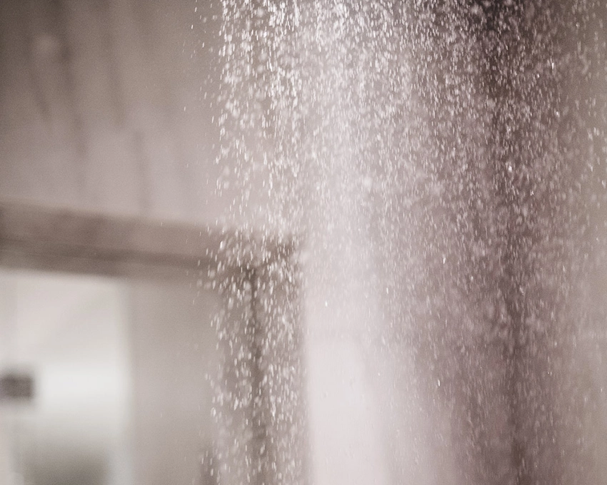 Fine jet of water in front of a smooth wall in the spa