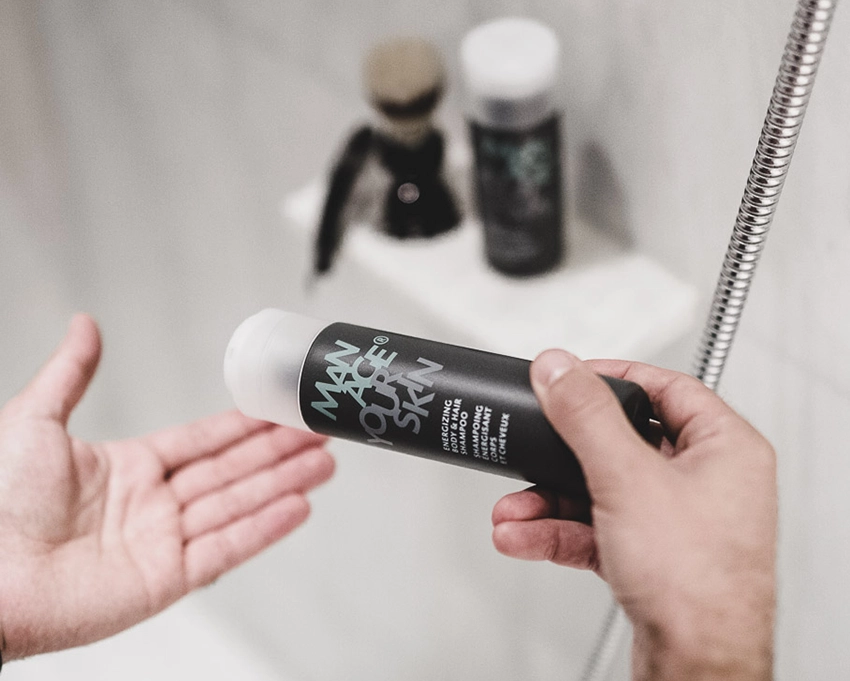 Man dosing the Energizing Body & Hair Shampoo onto his hand