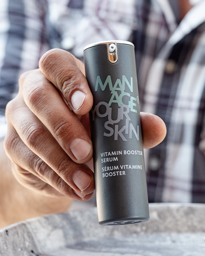 Man holding the Vitamin Booster Serum in his hand