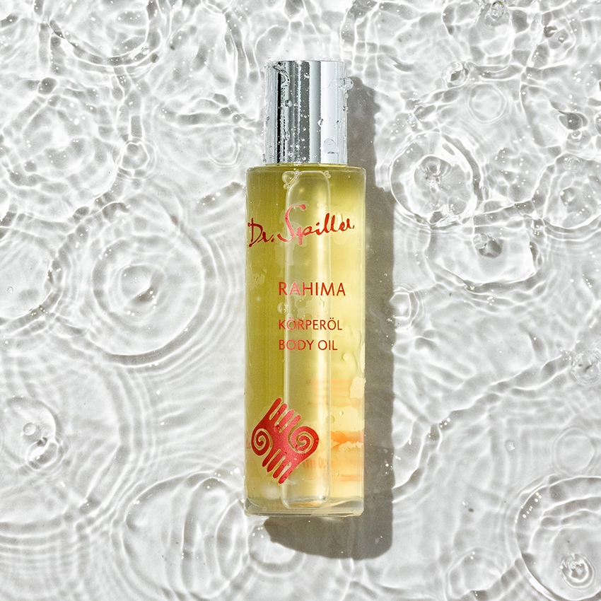 Rahima body oil lies in the clear water