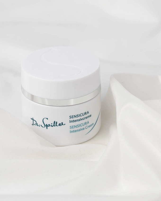 Sensicura intensive cream jar on a silk fabric