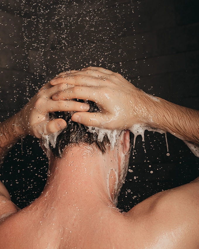 Man washes his hair with Energizing Body & Hair Shampoo