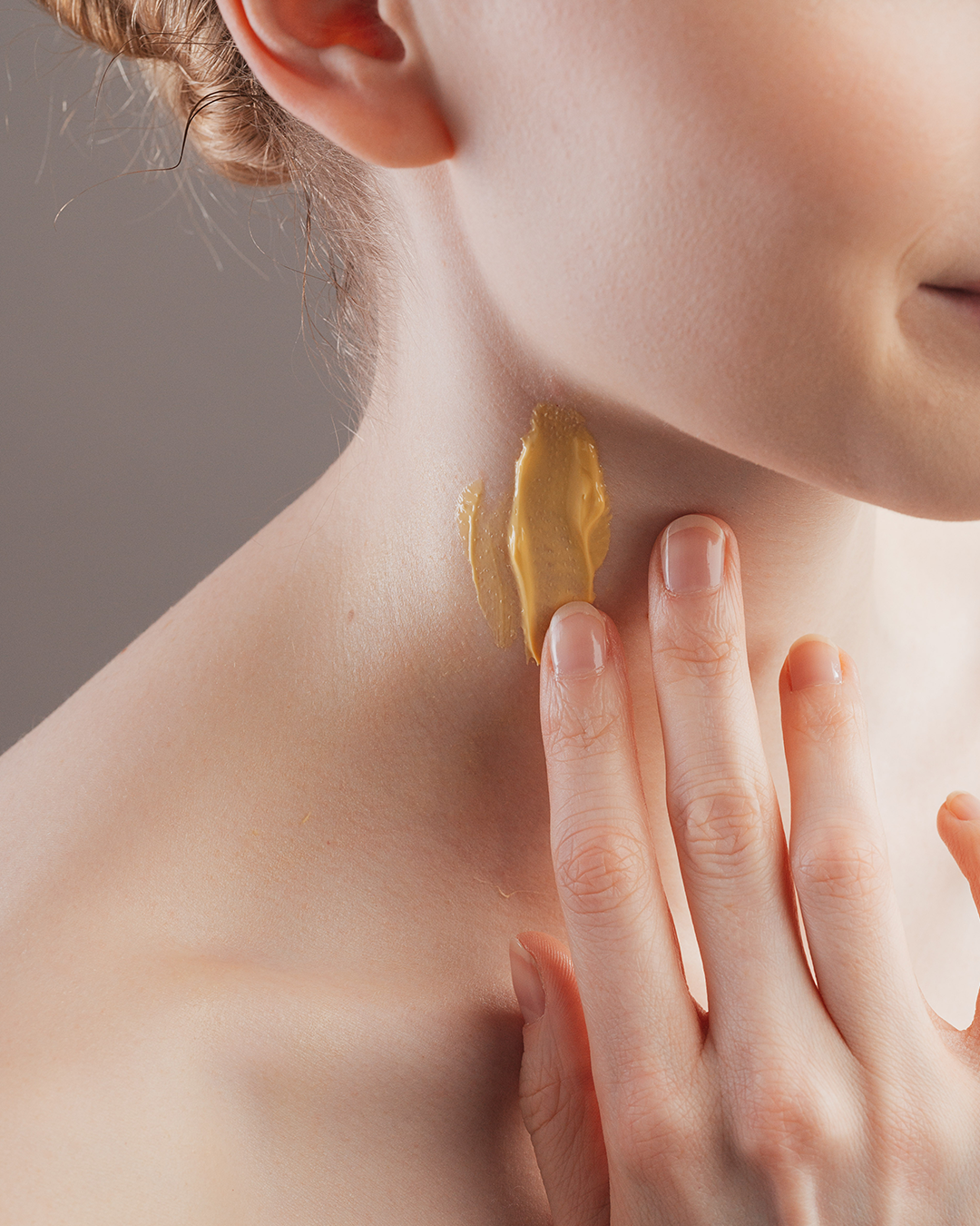 woman with cream on her neck